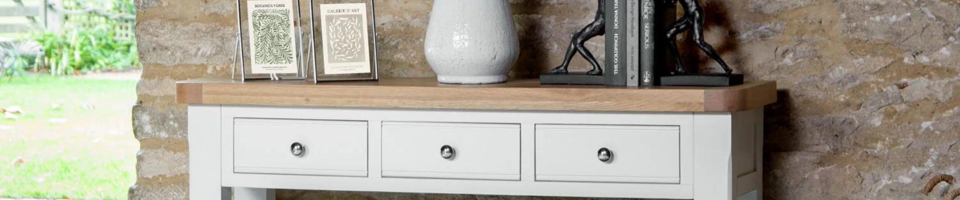 A chic living area featuring a stylish console table with decorative items and storage options, highlighting a range of modern and traditional designs.