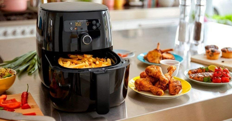 A sleek air fryer with essential cooking accessories, perfect for fast and healthy household meals.