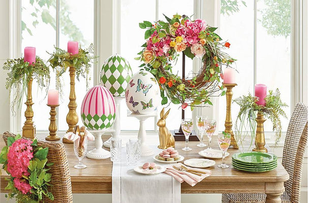 Colorful Easter eggs, spring flowers, and bunny figurines arranged as festive home decor centrepieces.