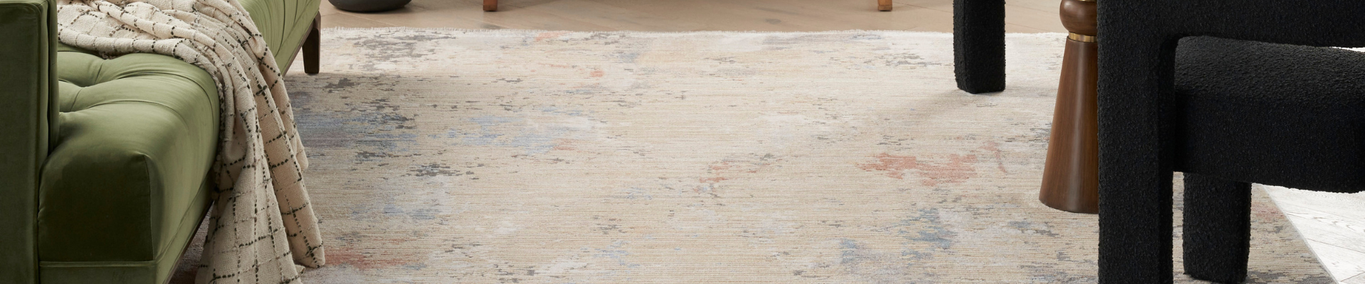A collection of vibrant Nourison Abstract Hues rugs displayed in a modern living room, showcasing unique patterns and rich color variations.