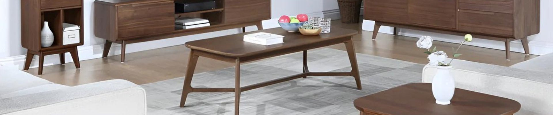 A stylish assortment of living room furniture including sofas, coffee tables, accent chairs, and side tables in a modern home setting.