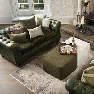 Luxurious Scatter Box ottomans, showcasing its versatile design for seating and coffee table use.