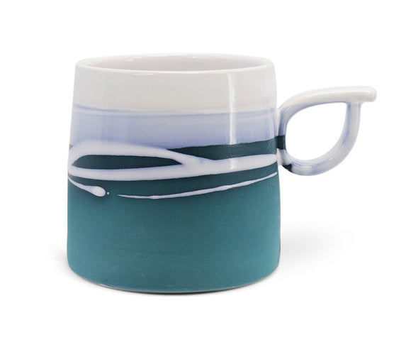 A close-up view of the Paul Maloney Teal Mug, showcasing its unique artistic design and exquisite craftsmanship.