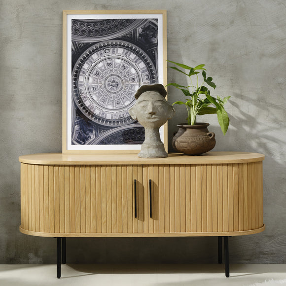 Wooden cabinet with decorative items against a gray wall