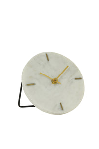 A beautifully crafted table clock with a white marble base and a stylish stand, perfect for adding sophistication to any space. Placed on a table, demonstrating its refined aesthetics and functional appeal