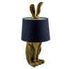 Antique gold lamp with rabbit ears design and black shade.