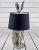 Elegant antique silver lamp with rabbit ears design.