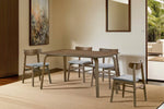 Oak dining chairs with modern walnut design.
