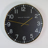 Baker and Brown Clocksmith Black/Brass 76 cm with white numeral display on the black background