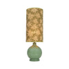 Bambou Olive Glass Table Lamp with Leaf Print Shade lit showing the bamboo leaf print shade and olive glass base