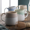 Belleek Living Coastal Mugs Set of 4 on a wooden table with a matcha whisk