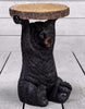 Adorable black bear holding tree trunk slice side table.