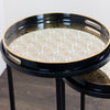 "Stylish black nest tables with gold accents"

