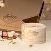 Butlers Marc de Champagne Powder Puff 200 g box styled on a gold table