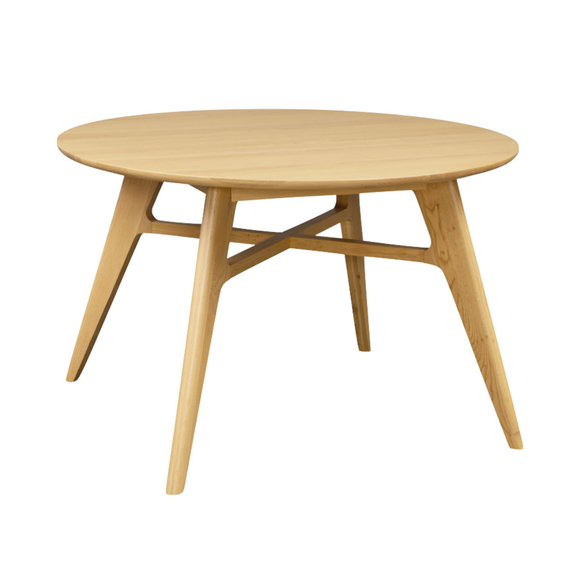 A sleek round oak dining table, perfect for modern homes.