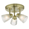 Antique brass bathroom lighting with ribbed glass shades

