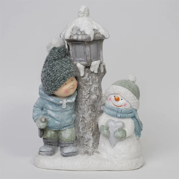 Elevate your holiday decor with the charming Boy and Snowman figurine featuring lights. Add a touch of festive whimsy and warmth to your space with this delightful and heartwarming holiday decoration.