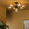 Cohen 7 Light Pendant Black/Clear Dimpled Glass life style picture