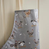 Cooksmart Hen House Lane Apron with Wipe Clean Coating grey with printed hens on it