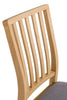 Slat back chair blending seamlessly into dining rooms.