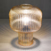 Demarius Table Lamp Amber Ribbed Glass with a beautiful light reflection