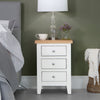 Modern comfort: a sleek white bedside table for your living space.