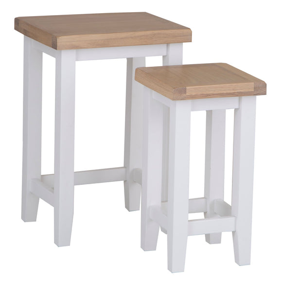 White nesting tables for versatile living spaces.