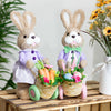 Adorable bunny figurine pushing a cart filled with eggs and flowers