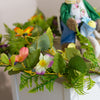 Spring garland with floral accents and pastel Easter ornaments.