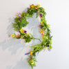 Festive Easter decor with colorful flowers and eggs for spring.