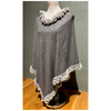 Elegant grey faux fur poncho layered for warmth.
