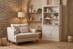 Fletcher Snuggle Chair in cream with loose back cushions and piping detail
