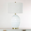 Modern lamp with shade featuring a satin gold stand and base
