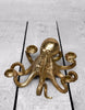 Decorative candlestick featuring a stylish gold octopus design.