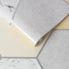 Wallpaper featuring a marble and stone-inspired geometric pattern.