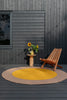 Brink & Campman Habitat Festival Outdoor Rug Yellow Round lifestyle picture outside