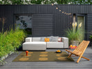 Brink & Campman Habitat Festival Dots Outdoor Rug Olive Green lifestyle picture of the rug outside