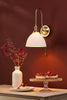 Hadano Wall Light Natural Brass and White Ceramic front view life style picture
