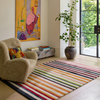 Harlequin Calla Bohemian Rug Pomegranate/Clementine lifestyle picture in the living room