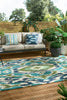 Harlequin Ixora Outdoor Rug Emerald Palm Chartreuse lifestyle picture outside
