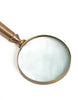 Elegant brass magnifying glass, perfect for detailed reading.