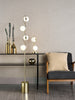 Lysandra 4 Light Floor Lamp Polished Gold with Opal Glass Shades life style picture with table lamp
