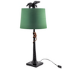 Black palm tree with climbing monkey table lamp with green shade.