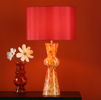 Enhance your decor with our stunning red confetti glass lamp.