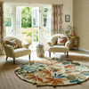Sanderson Robins Wood Floral Rug Russle Brown Round lifestyle picture in the living room