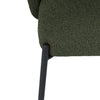 Close-up of a green upholstered chair with a black metal leg on a white background