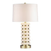 Yara table lamp with stacked rounded travertine base, gold-toned accents and light fabric shade