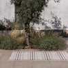 Brink & Campman Zona Line Outdoor Rug Charcoal lifestyle picture outside
