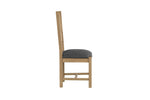 Oak dining chairs featuring a padded seat
