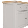 White sideboard featuring three drawers and two doors.
